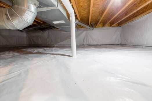 A clean, encapsulated crawl space with a plastic vapor barrier covering the floor and walls, exposed ductwork, and visible wooden ceiling joists.
